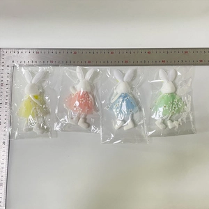 Easter rabbit plush toys in colorful tulle dresses shown with ruler for size reference