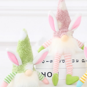 Easter rabbit gnomes plush with long ears and striped hats in macaron colors on books