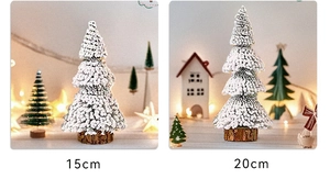 Close-up of 15cm and 20cm mini flocked Christmas trees with rustic wood bases