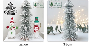 Detail view of snowy cedar trees and wooden snowman tabletop Christmas ornaments