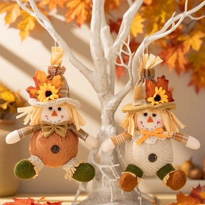 Harvest gnome ornaments featuring plaid hats and sunflowers hanging on a decorative branch