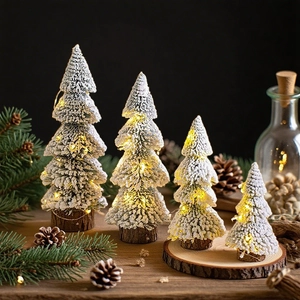 Set of four mini flocked cedar trees with LED lights and solid wooden bases for tabletop decor
