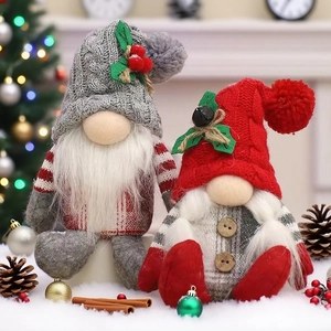 Christmas gonk gnome dolls with knitted hats and festive accessories on a snowy background