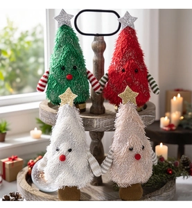 Detail view of plush Christmas tree dolls in four colors on a cozy wooden tray