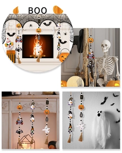 Halloween wood bead garland with pumpkin and ghost charms hanging on a white wall decor