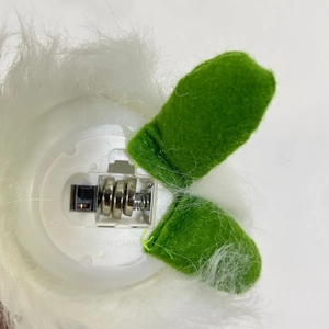 Detail of plush forest man doll base with battery compartment and power toggle switch