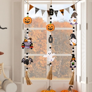 Three Halloween wood bead garlands with ghosts, pumpkins and tassels on white shutters