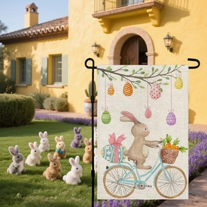 Easter bunny riding bicycle garden flag with colorful eggs in a sunny yard setup