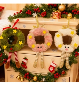 Detailed view of plush Christmas wreath ornaments with cute character legs and star sequins