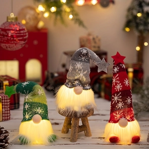 Three Christmas glowing gnomes with LED lights in red, green, and grey knitted hats
