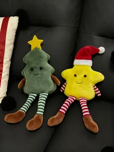 Detail of plush Christmas tree and star dolls with striped long legs on a black sofa