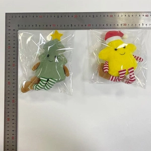 Detail of Christmas star and tree plush dolls with striped long legs in packaging