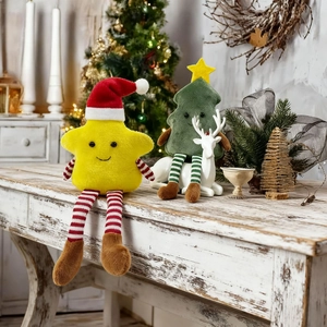 Star and Christmas tree plush dolls with long striped legs on a festive white wooden table