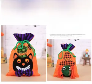 Detail of velvet Halloween candy bags with black cat and witch drawstrings