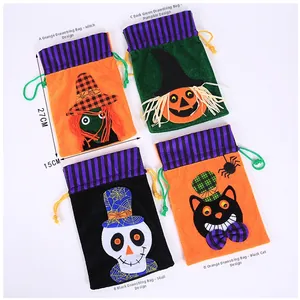 Detail of four velvet Halloween drawstring gift bags with witch and pumpkin appliques