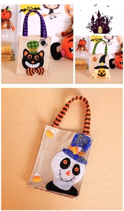Close-up of Halloween burlap candy bags with black cat, wizard, and skull felt appliques