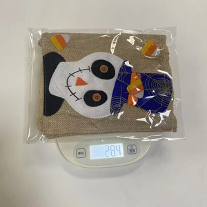 Weight display of Halloween linen candy bag with scarecrow design at 28.4g on scale