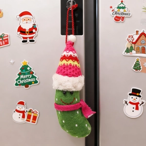 Handmade green felt pickle ornament with knitted pink hat and scarf for Christmas decor