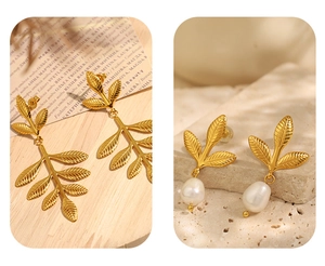 Detail of vintage gold leaf earrings with textured finish and a baroque pearl drop