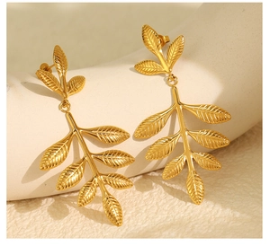 Detailed view of vintage gold leaf earrings with intricate branch texture and dangle design
