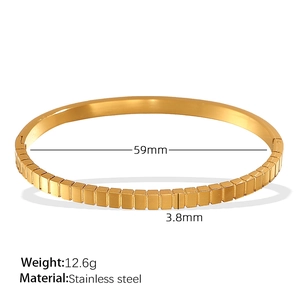 Golden stainless steel bangle with square grid pattern and 59mm inner diameter