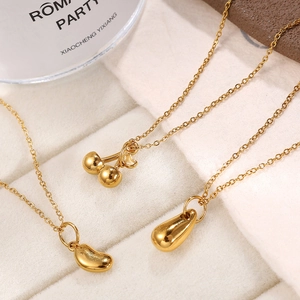 Golden pendant necklaces with cherry, bean, and teardrop shapes in polished finish