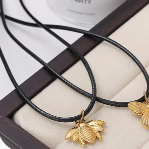 Exquisite 18K gold plated bee pendants on black braided cords in a luxury jewelry display box