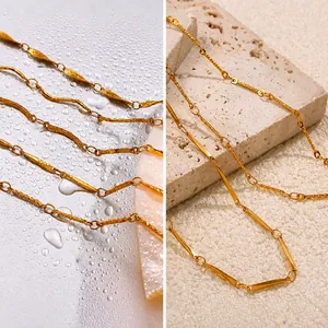 Macro shot of 18K gold plated stainless steel textured bar chain necklace on stone