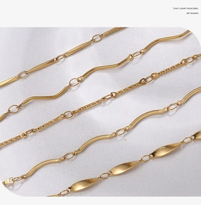 Detailed macro shot of four diverse 18K gold plated stainless steel chain styles