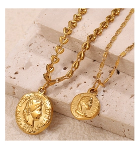 Detailed macro of 18K gold plated stainless steel coin pendants with vintage carvings