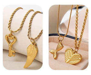 Detailed view of four golden necklaces featuring key, wing, fishtail, and heart pendants