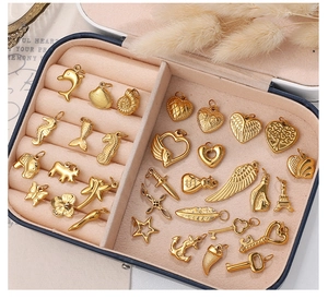 Detailed close-up of various gold-plated sea life and mixed charms in a jewelry box