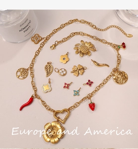 Close-up of 18K gold-plated chunky necklace with sun flower and fruit-shaped charms