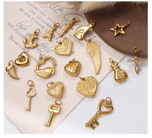 Detailed view of assorted golden DIY charms like starfish, shells, and hearts on a display