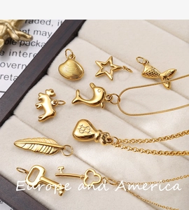 Detailed set of gold marine life pendants including starfish shells and whale tails charms