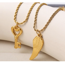Detailed macro view of gold-plated rope chain necklaces with heart-key and wing pendants