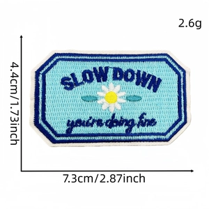 Blue embroidered 'Slow Down' patch with daisy flowers for clothes and bags decoration