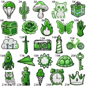 Macro display of 25 green embroidered patches with detailed stitching for clothing