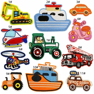 Detailed view of eleven colorful embroidered vehicle patches including cars and trucks