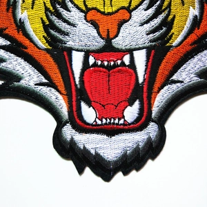 Detailed tiger head embroidery patch with vivid orange and yellow silk thread texture