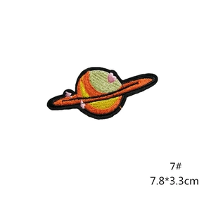 Detail of embroidered planet patch with yellow sphere and orange ring, size 7.8x3.3cm