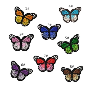 Detailed close-up showing eight colorful butterfly embroidery patches with vibrant textures