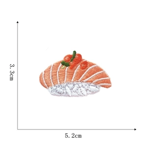 Detailed salmon sushi embroidery patch showing size dimensions 5.2cm by 3.3cm on white backdrop