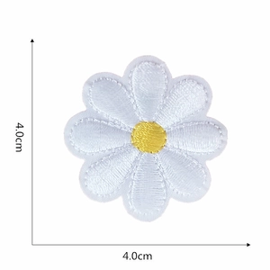 Detail showing white daisy embroidery patch with yellow center, sized 4.0cm by 4.0cm