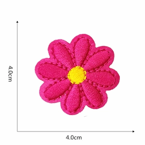 Detailed macro view of a pink and yellow floral embroidery patch measuring 4.0cm