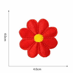Detailed embroidery texture of a red and yellow daisy flower patch measuring 4.0cm x 4.0cm