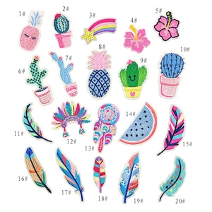 Detail view of 20 embroidered patches featuring cactus, pineapple, and feather designs