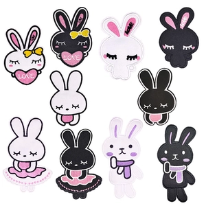 Detailed view of assorted black and white rabbit embroidery patches with heart motifs