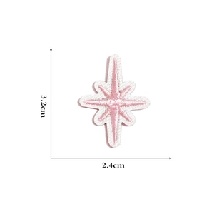 Detail of pink star embroidery patch with dimensions 3.2cm by 2.4cm on white background