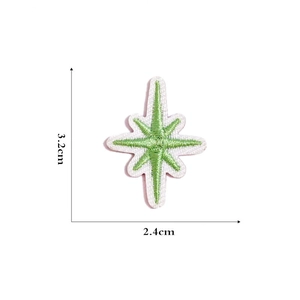 Self-adhesive green star embroidered patch with dimensions 3.2cm by 2.4cm on white background